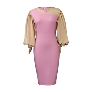 Detail of color-block dress with V-neckline and lantern sleeves featuring cuff tie accents