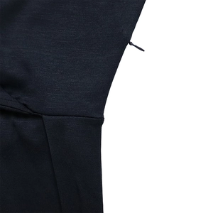 Close-up of invisible zipper and stitching on navy blue dress fabric with texture