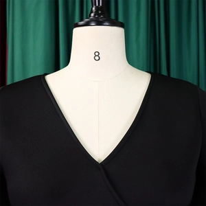 Detail of elegant black V-neck overlapping neckline on a knitted evening dress for women