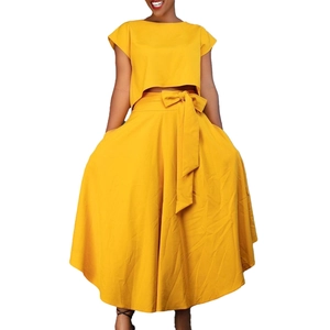 Bright yellow two-piece plus size set with crop top, maxi skirt and bow belt