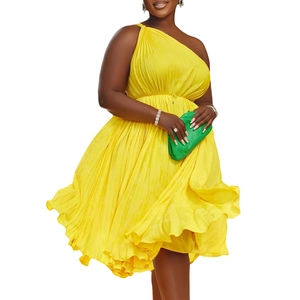 Detailed texture of vibrant yellow pleated one-shoulder dress with elegant waist tie