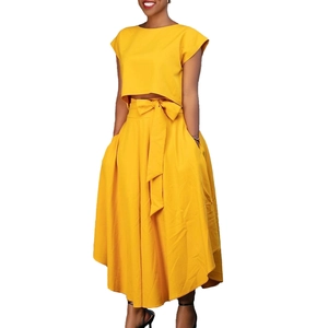 Detail view of high-waist flared skirt with belt and side pockets in ginger yellow