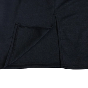 Detail shot of black knitted dress hem featuring a side slit and double-stitched edging
