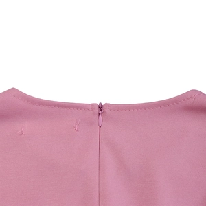 Macro detail of the invisible back zipper and stitching on this pink long sleeve dress