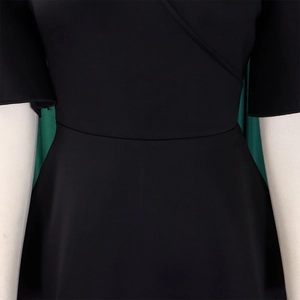 Detail of elegant black dress showing crossover V-neckline and fitted high waist seam
