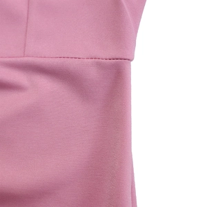 Macro view of pink dress waistline showing neat stitching and knitted fabric texture