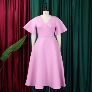Detail of pink flare sleeves and wrap V-neckline on high-waist A-line party dress