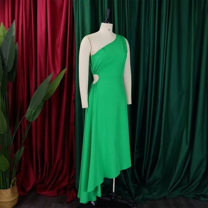 Detail of green one-shoulder dress featuring waist hollow-out and asymmetrical hem