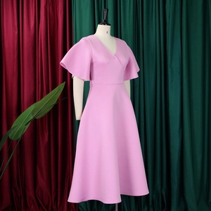 Detailed view of pink V-neck dress with ruffle sleeves and full skirt on a mannequin