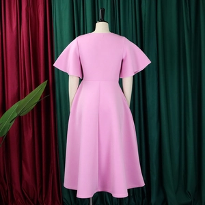 Detail view of pink flare sleeve dress with waist tie and A-line pleated skirt on mannequin