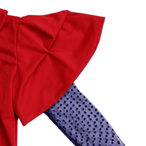 Detail of red ruffled sleeve with dark blue polka dot mesh splice and contrast fabric texture