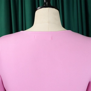 Close-up of pink knit dress collar with high-quality stitching and smooth texture