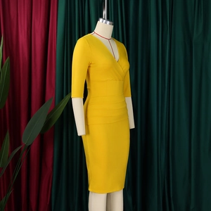 Detail of elegant bright yellow V-neck fitted dress with stylish side ruching texture