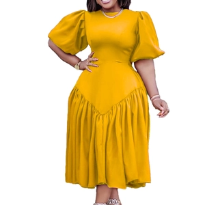 Dettaglio del vestito midi giallo zenzero con maniche a sbuffo e gonna a pieghe a strati