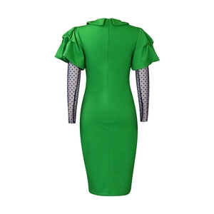 Detail of green mesh dress with polka dot puff sleeves and hidden back zipper