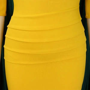 Detailed macro view of the yellow ruched fabric texture and pleated design on this dress