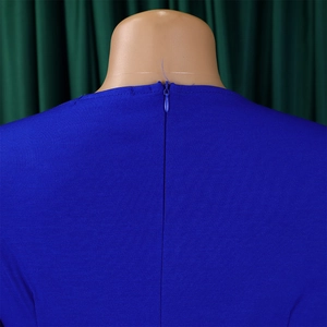 Detail shot of a bright blue dress featuring a hidden zipper back and plain weave fabric