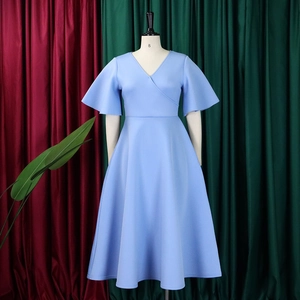 Detail of light blue A-line dress featuring a V-neckline and elegant ruffle sleeves