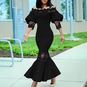 Detail of the off-shoulder neckline and lace trim on a black fishtail evening dress