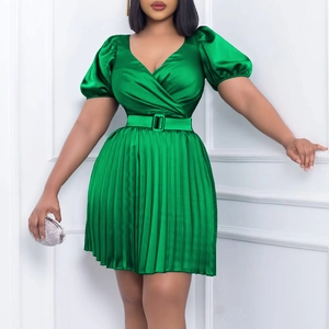 Detail of green satin V-neck mini dress with puff sleeves and pleated skirt details