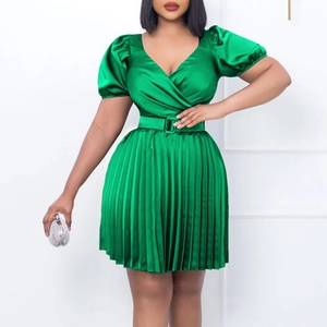 Detailed view of bright green V-neck pleated satin dress with stylish puff sleeves