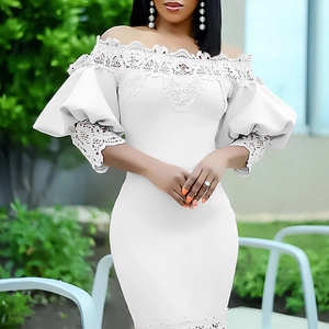 Detailed close-up of white off-shoulder dress featuring intricate lace and lantern sleeves