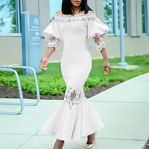 Detail of elegant white off-shoulder mermaid dress with intricate lace trim and puffed sleeves
