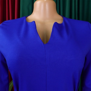 Detail of royal blue V-neck dress featuring unique textured knit fabric and elegant seams