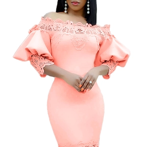 Detailed view of the coral off-shoulder dress featuring intricate floral lace and puff sleeves