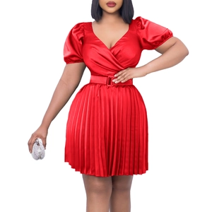 Detail of red V-neck pleated dress featuring a matching waist belt with square buckle