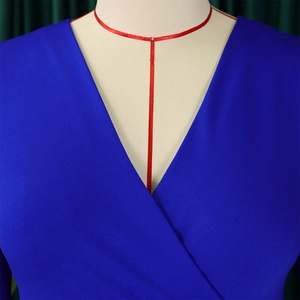 Detailed view of royal blue V-neck wrap dress with textured twill fabric and elegant pleats