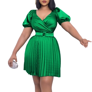Detail of green satin mini dress with V-neck wrap design and pleated skirt with belt