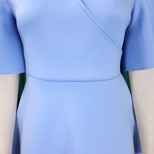Detail of cross V-neck wrap dress with short sleeves in light blue fabric