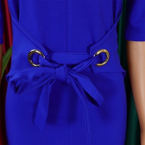 Close-up of royal blue dress waist with a golden metal ring and self-tie bow detail