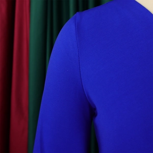 Detail view of royal blue knit fabric showing fine texture and professional stitching
