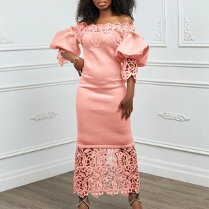 Close-up of coral pink off-shoulder dress with lace floral embroidery and lantern sleeves