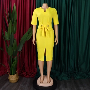 Detail of elegant yellow V-neck pencil dress featuring waist belt and front slit design