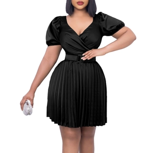 Close-up of black satin V-neck dress with pleated skirt and waist belt detail