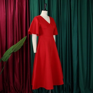 Detail of red V-neck midi dress with flared ruffle sleeves and large A-line skirt
