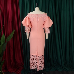 Rear view of coral pink off-shoulder dress with lace trim and lantern sleeves