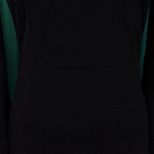 Detail shot of the waist seam and smooth black fabric on a long sleeve dress