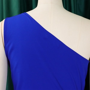 Detail of royal blue one-shoulder dress with high-elastic fabric and fine stitching