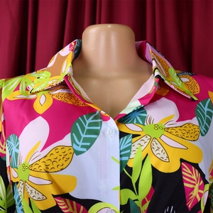 Close-up of tropical floral print shirt featuring a sharp collar and white buttons