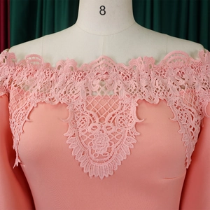 Detail of pink evening dress featuring intricate lace neckline and long puff sleeves