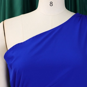 Detailed close-up of the shoulder stitching and neckline of a royal blue one-shoulder dress