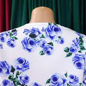 Détail de l'imprimé floral rose bleue sur le haut blanc à col rond avec texture de tissu
