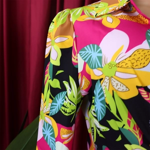 Close-up of tropical floral print on smooth long sleeve shirt fabric with leopard details