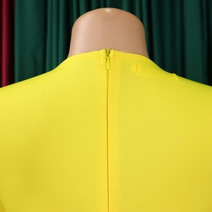 Macro view of yellow pencil dress neckline featuring a hidden zipper and honeycomb texture