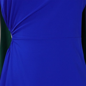 Close-up detail of royal blue dress featuring ruched side seams and fine knit fabric texture