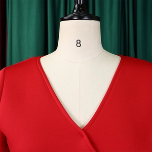 Detail of red V-neck wrap dress bodice with neat stitching on a size 8 mannequin